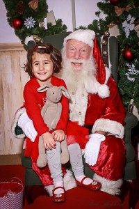 A girl with her bunny and Santa Claus